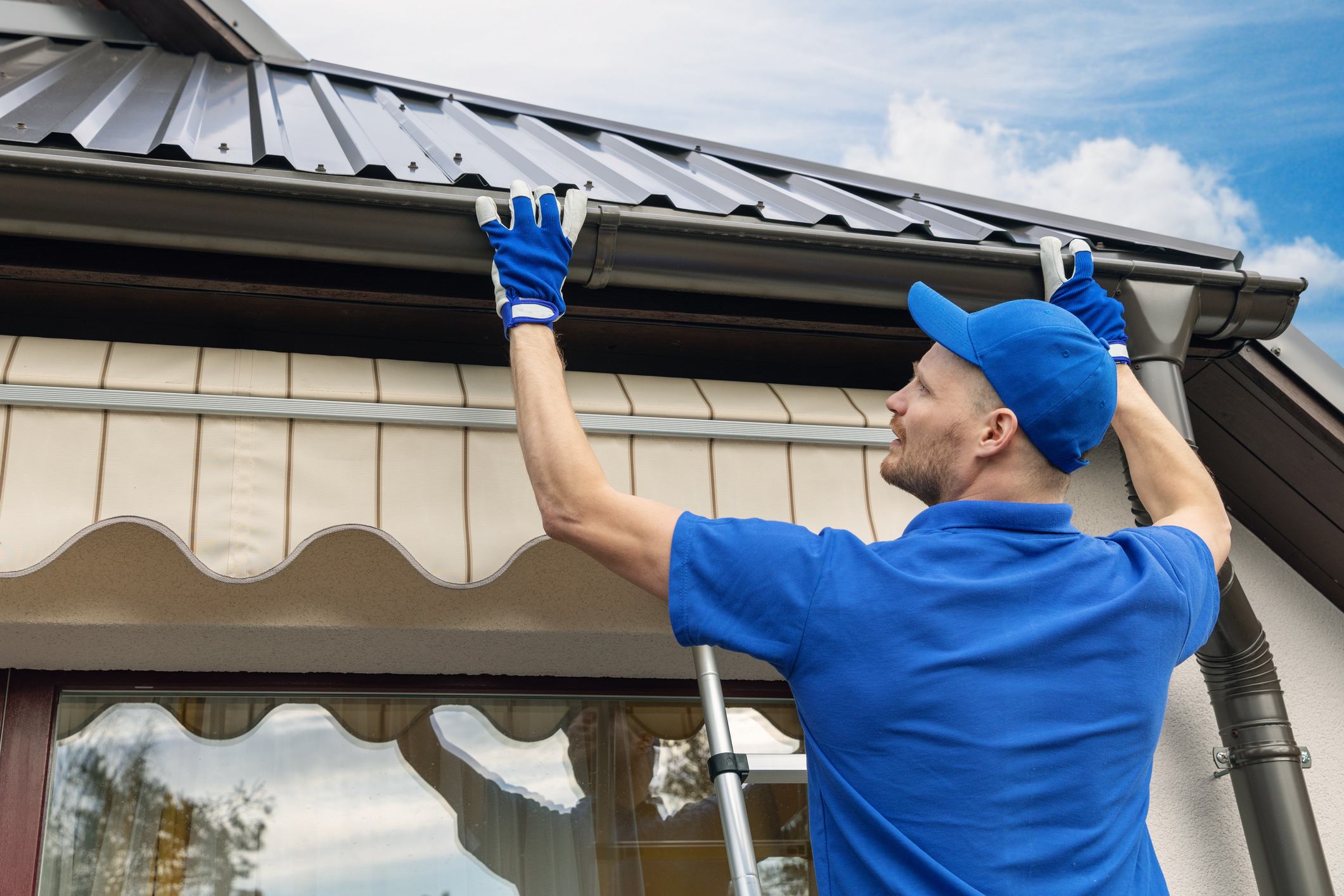 Clean home exterior showing properly maintained gutters during spring.