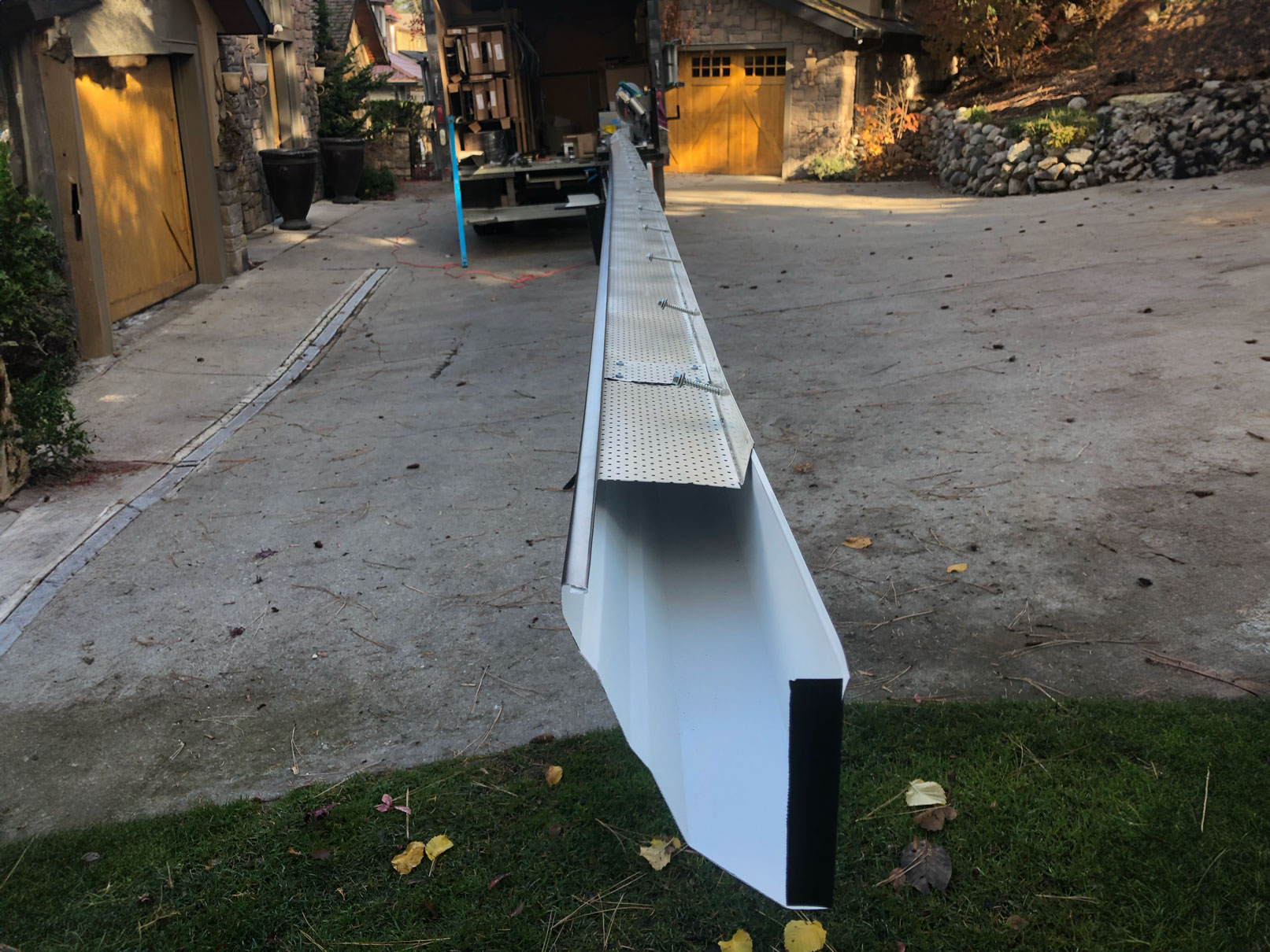 "Aluminum leaf guard system installed on residential gutters."