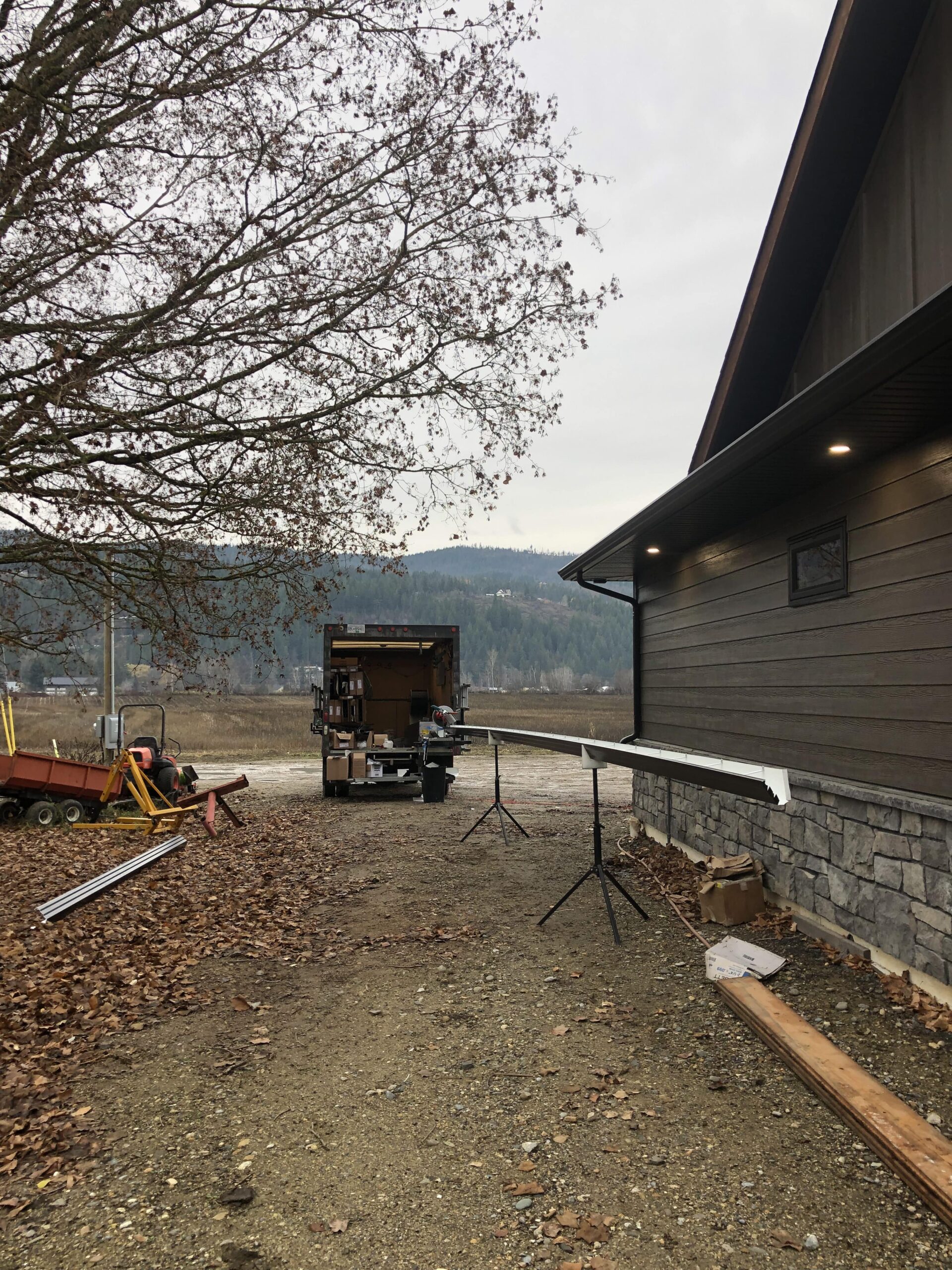 Clean gutters on an Okanagan home surrounded by fall leaves after professional seasonal maintenance by Heimann Gutters.